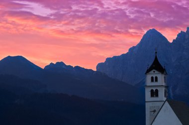 Dolomites Church Colle Santa Lucia at sunrise, Alps, Italy clipart
