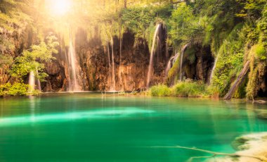Waterfall with sun at Plitvice Lakes National Park, Croatia clipart