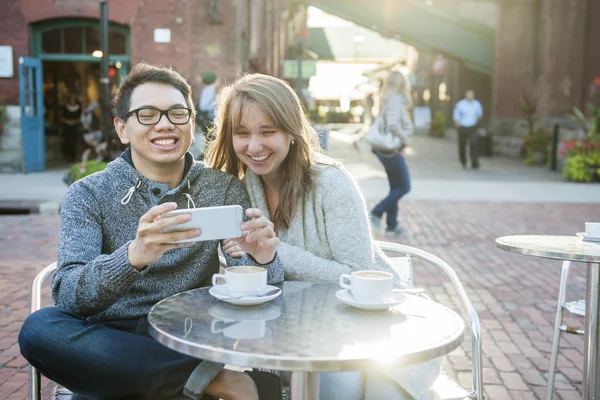 Двоє людей зі смартфоном у кафе — стокове фото