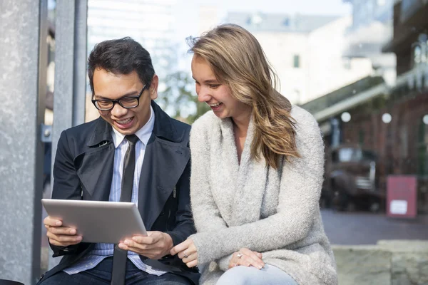 Two young people with digital tablet — Stock Photo, Image