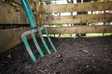 Garden fork turning compost clipart