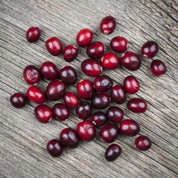 Cranberries on rustic wood — Stock Photo, Image