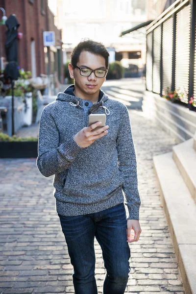 Young asian man on city street — Stock Photo, Image