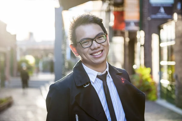 Young asian man on city street — Stock Photo, Image