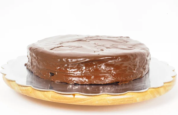 Sacher chocolate cake on a silver plate on wooden board towards — Stock Photo, Image