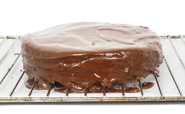 Chocolate icing dripping off from freshly made sacher torte cake — Stock Photo, Image