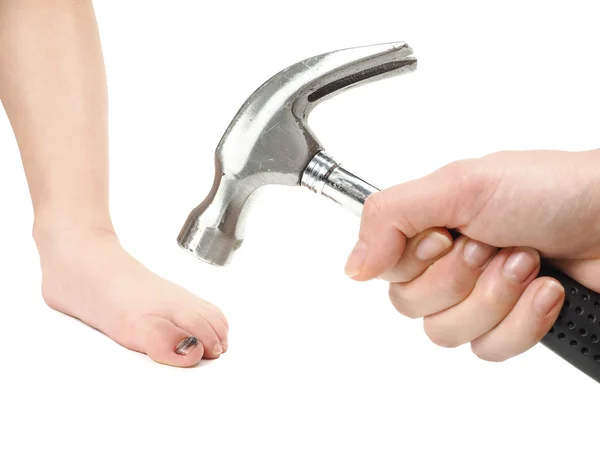Someone holding a hammer over a child's foot with blue hallux na — Stock Photo, Image