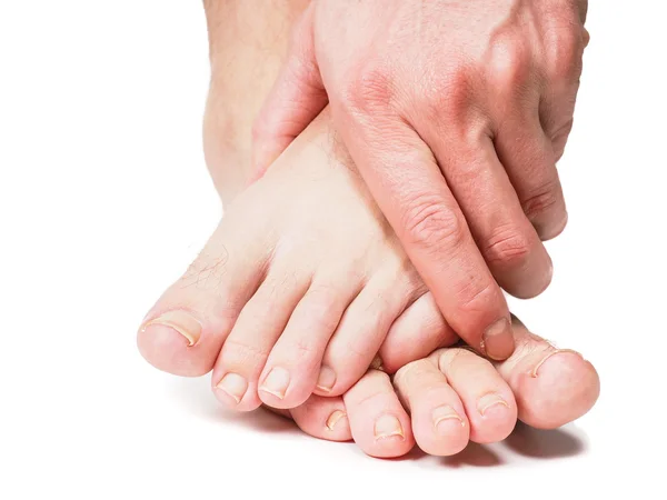 Male person holding onto feet — Stock Photo, Image