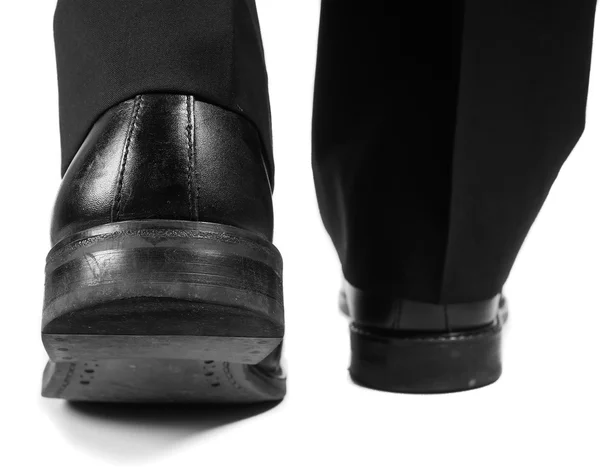 Male suit walking away in black worn shoes — Stock Photo, Image