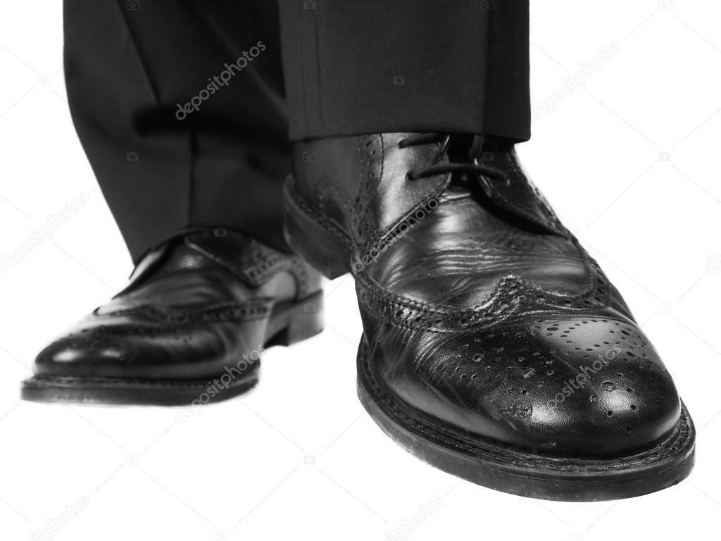 Person approaching in black shoe and suit