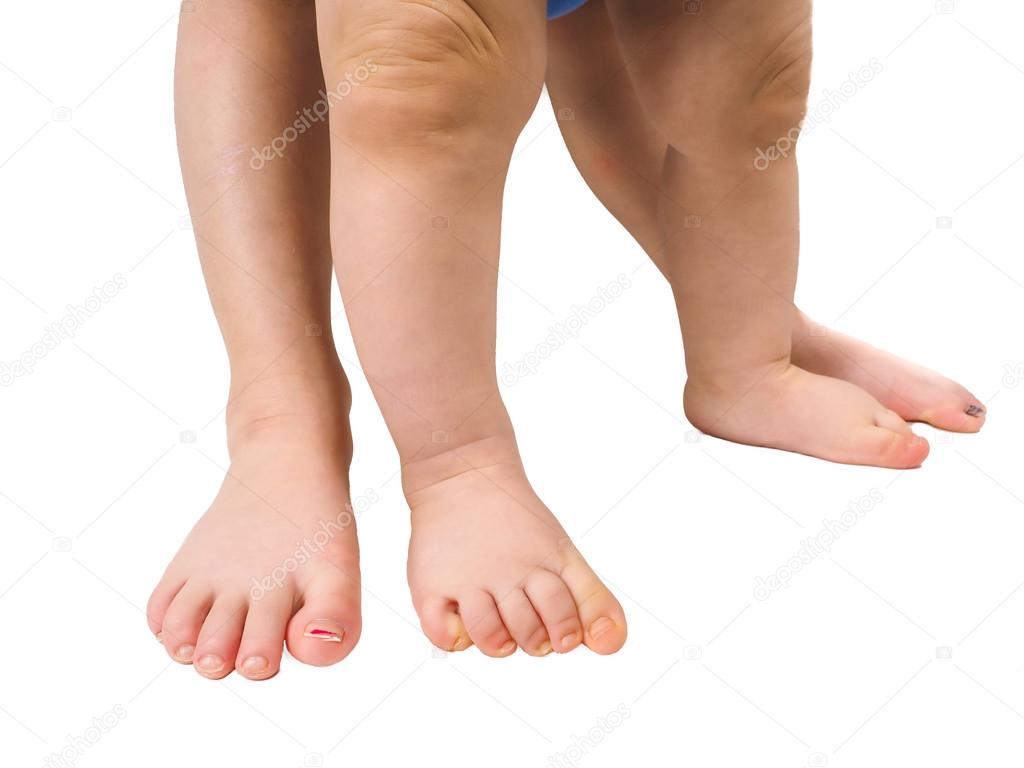 Barefoot young children standing towards white