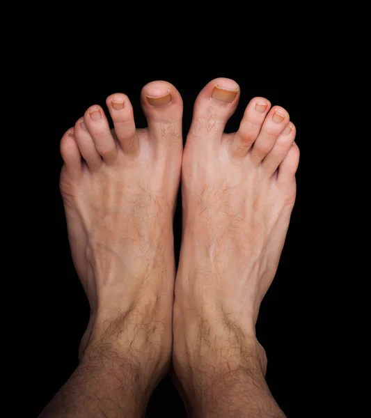 Pair of caucasian male feet isolated towards black — Stock Photo, Image