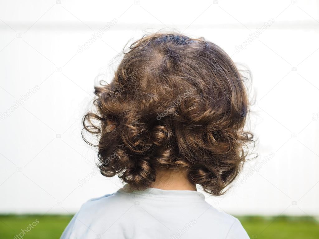Little caucasian person with curly hair