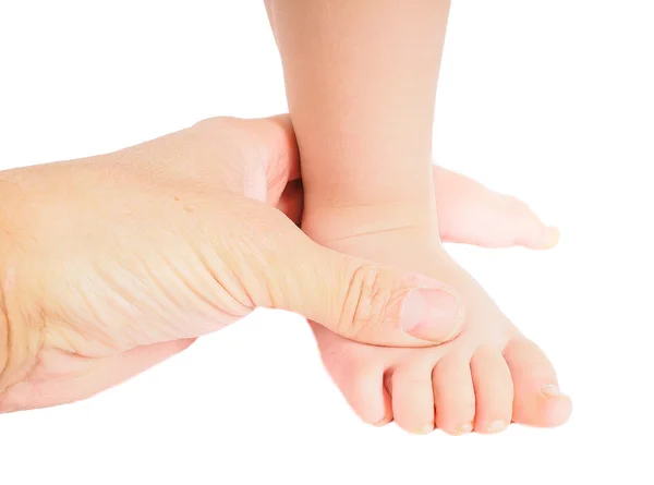 Male hand holding firmly around a foot of toddler isolated on wh Stock Photo