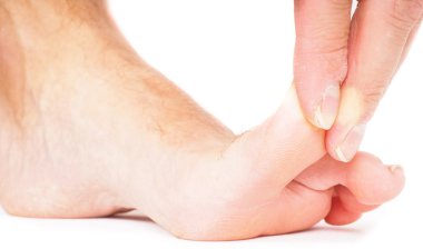 Erkek kişi başparmağı geriye doğru üzerinde beyaz izole çekerek