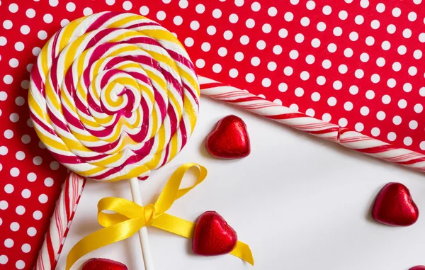 Lollipop on a red polka dot background — Stock Photo, Image