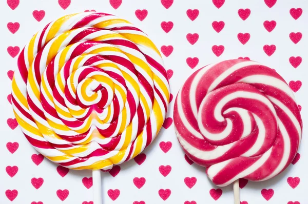 Lollipops on a background with hearts — Stock Photo, Image