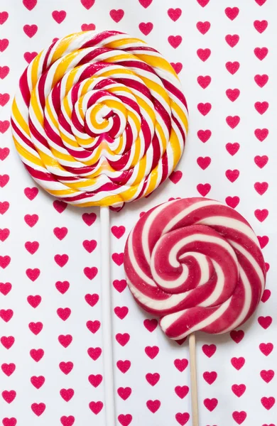 Lollipops on a background with hearts — Stock Photo, Image