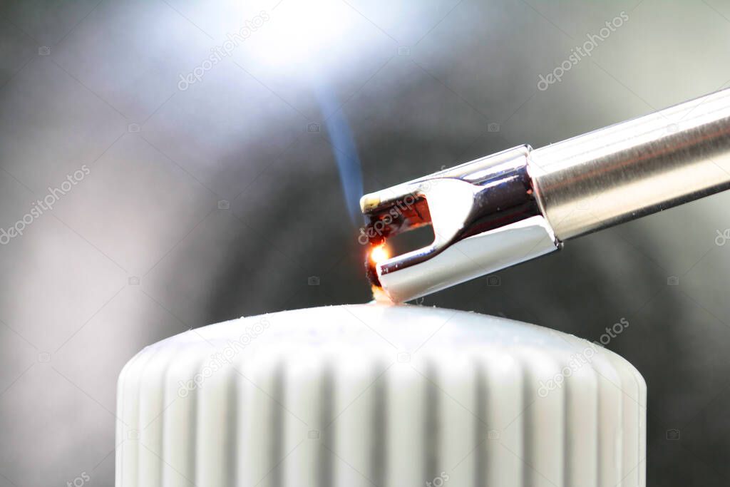 Tesla lighter ignites candle wick