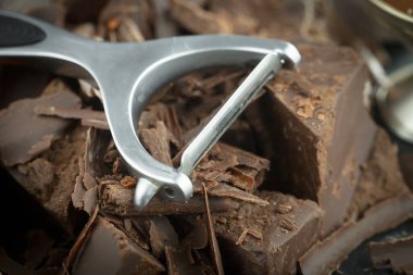 Eskimiş bir arka planda kakao çekirdeği ve fındıklı siyah çikolata..