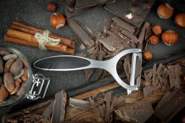 Eskimiş bir arka planda kakao çekirdeği ve fındıklı siyah çikolata..