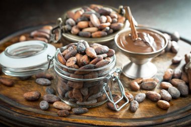 Cocoa beans on old background