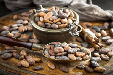 Cocoa beans on old background