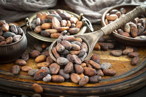 Cocoa beans on old background
