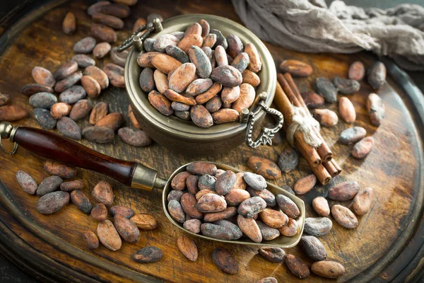 Cocoa beans on old background