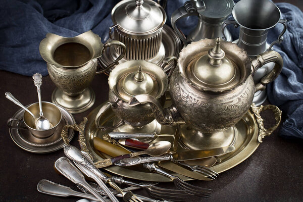 Silver dishes on old background