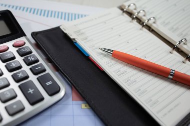 Ofisteki iş ve muhasebe öğeleri masanın üzerinde, kompozisyonda sergilenmiş..