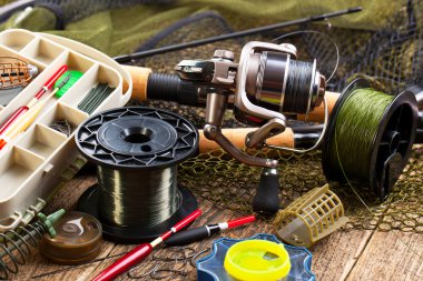 fishing tackle on a wooden table clipart