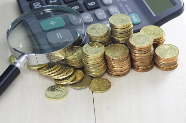 Gold coins, Calculator and Magnifying Glass - Business Concept — Stock Photo, Image