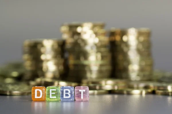 Debt text and gold coin — Stock Photo, Image