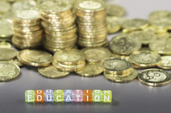Education text and coins — Stock Photo, Image