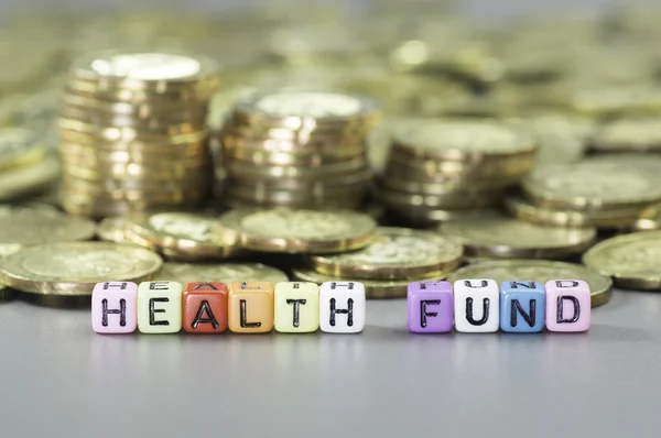 Gezondheidsfonds en gouden munten — Stockfoto