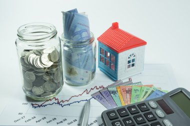 Coins, Jar and House in the background clipart