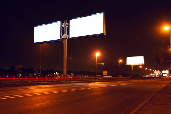 Big white billboard on lighting night street — Stock Photo, Image