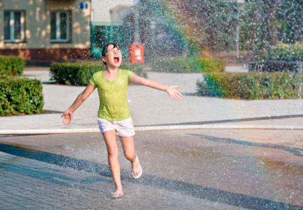 Girl is running through fountains