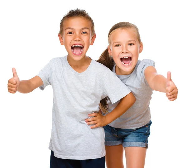 Niño y niña están mostrando el pulgar hacia arriba signo —  Fotos de Stock