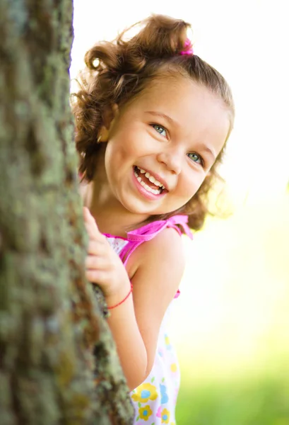 Cute little girl is playing hide and seek — Stock Photo, Image