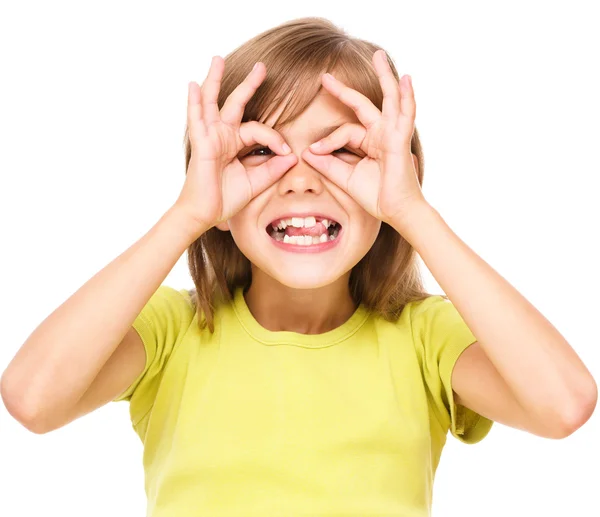 Happy little girl is showing glasses gesture — Stock Photo, Image