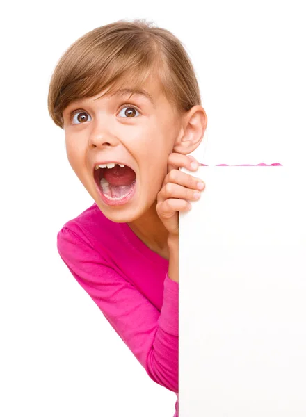 Little girl is looking out from the blank banner — Stock Photo, Image