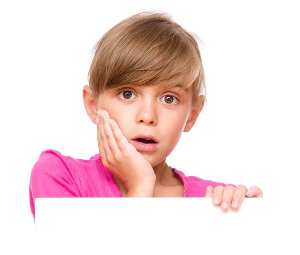 Little girl is looking out from the blank banner — Stock Photo, Image