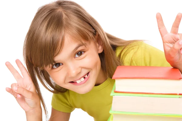 Menina com uma pilha de livros — Fotografia de Stock