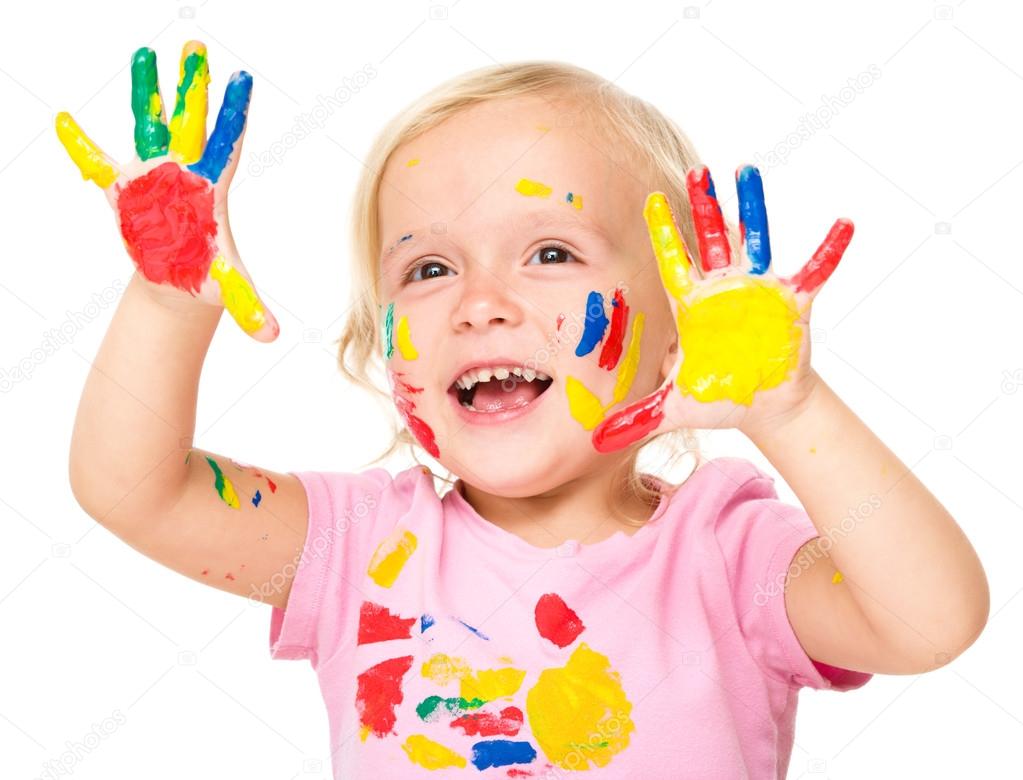 Portrait of a cute little girl playing with paints