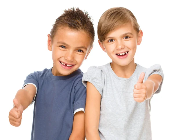 Little boy and girl are showing thumb up sign — Stock Photo, Image