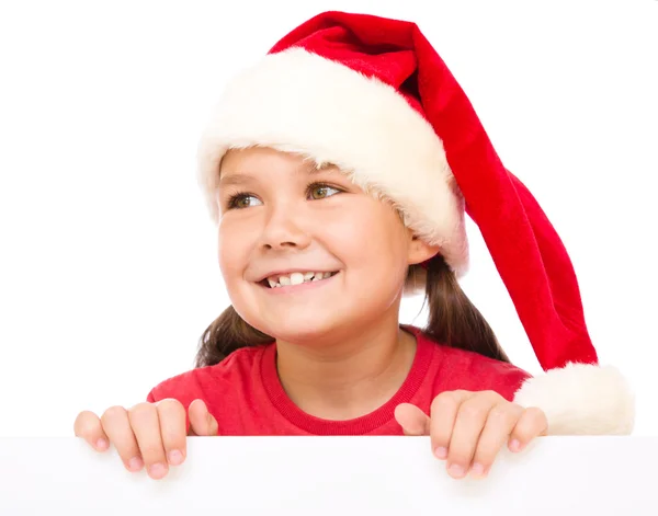 Malá holčička v santa hat drží prázdné desky — Stock fotografie