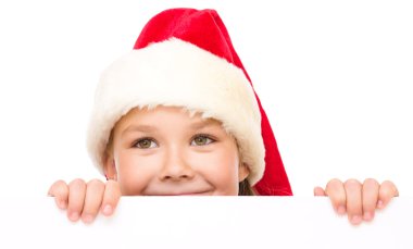 Noel Baba şapkası, küçük kız Pano düzenliyor