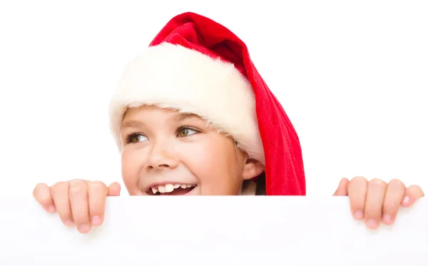 Klein meisje in Kerstman hoed houdt leeg bord — Stockfoto
